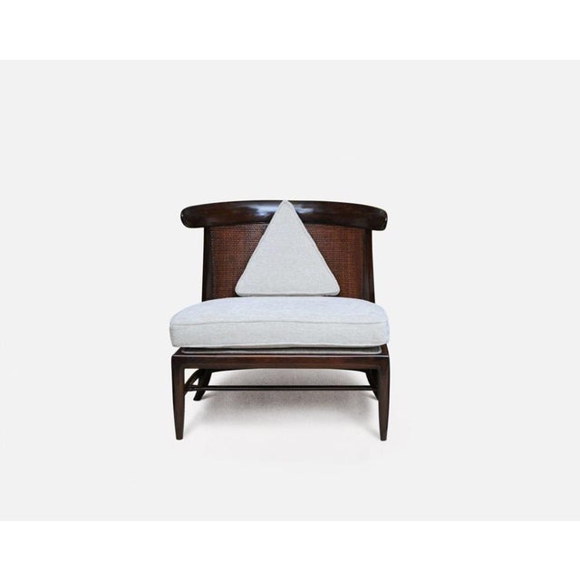 Fine original condition, this is a scarce walnut slipper chair with original cane back. Model no. 650 designed by John...