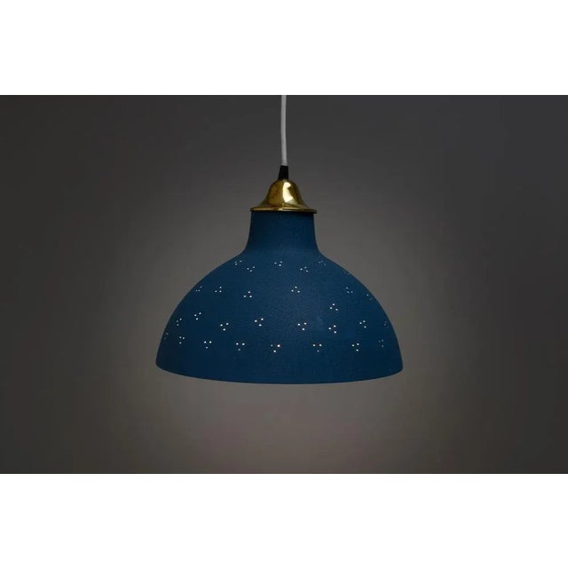 Mid-Century Swedish rise and fall pendant light. In a textured blue finish on the exterior with a cream interior of the...