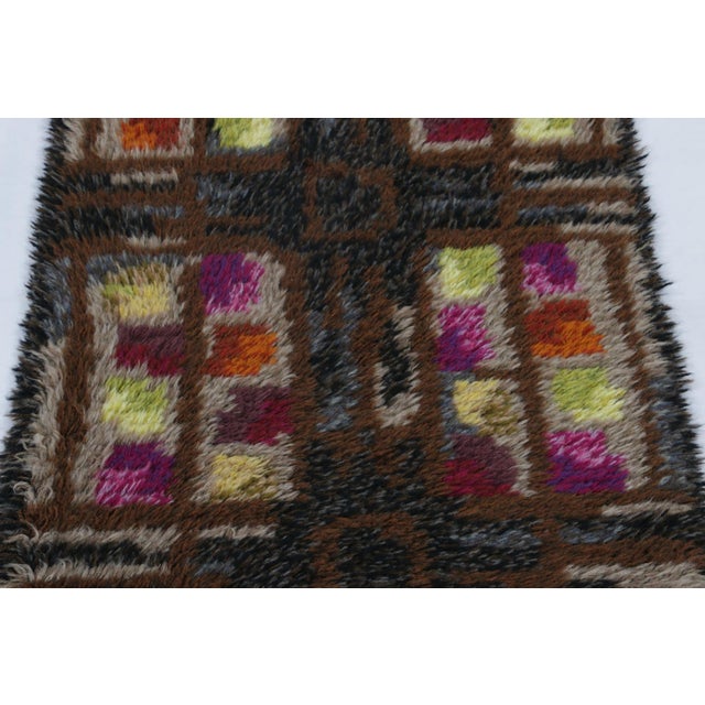 Hand-knotted in lush, high-pile wool in Sweden circa 1960-1970, this 2x4 vintage Swedish Rya runner rug is a bold new...