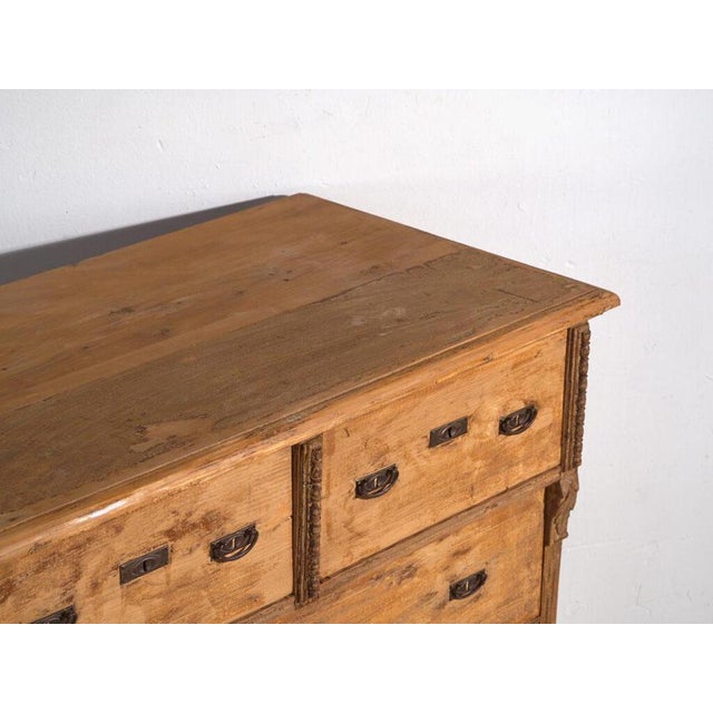 Antique solid pine chest of drawers from Central Europe, crafted circa 1920, featuring a primitive rustic aesthetic and...