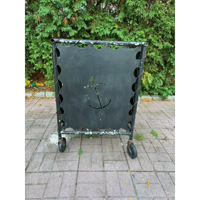 This post war, mid-century modern nautically themed bar cart is rendered in aluminum. The cart features plenty of storage...