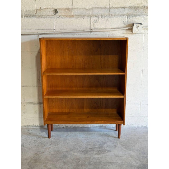 Featuring clean lines and open shelving, this piece offers functional storage with minimalist charm. Simple tapered legs...