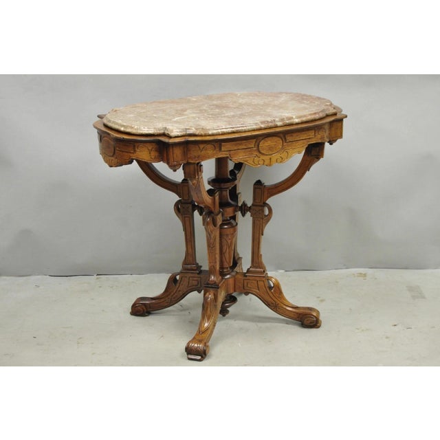 Antique Eastlake Victorian Carved Walnut Marble Top Pedestal Base Parlor Lamp Table with Shaped Top. Circa Late 19th...