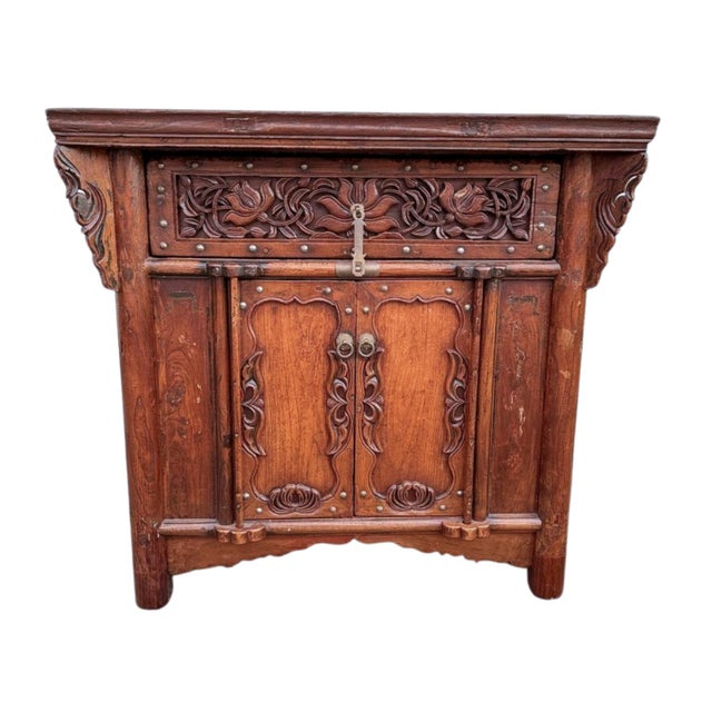 A substantial antique Chinese cabinet table from Shanxi Province, featuring deeply carved floral openwork panels, hand-...
