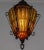 An amber, crackle, caged glass lantern pendant light from the mid 20th century; in an elegant shape with a decorative cap...