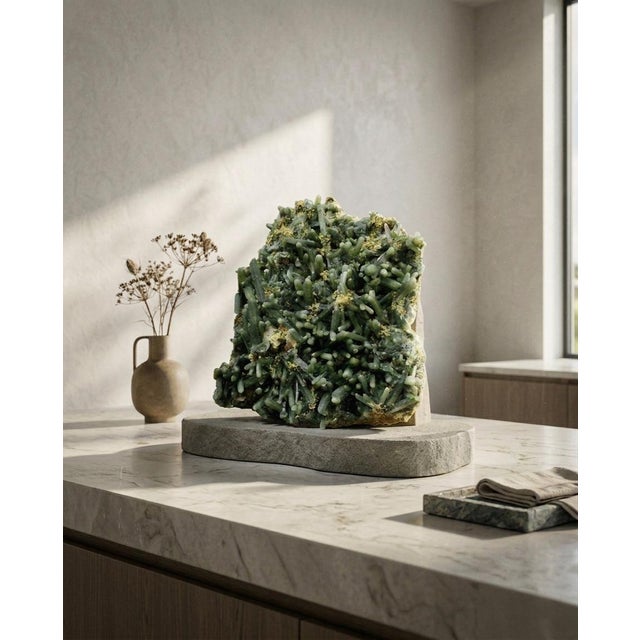 A raw sculptural Hedenbergite and native sulfur mineral specimen selected for its dark forest-green crystalline matrix,...
