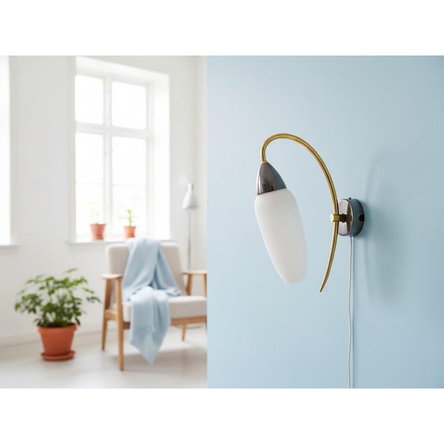 This minimalist wall sconce can be used with the shade facing upwards or downwards, whichever you like most. It is made of...