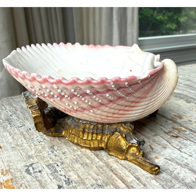 French pink scallop shell fastened to a brass base of highly detailed double seahorses. Great little catch all.