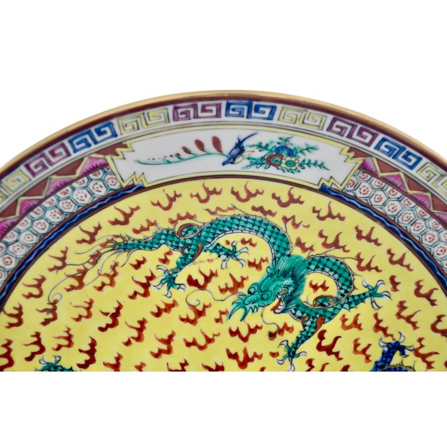 Large 14 inch decorative plate or bowl with raised relief imperial dragon design hand decorated and glazed in yellow,...