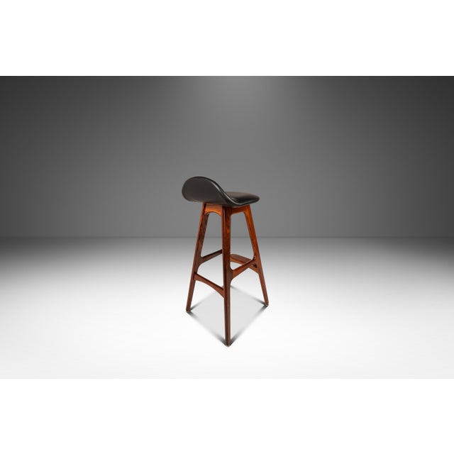 Introducing a rare Model OD-61 counter-height barstool designed by the influential Erik Buch for the lauded Odense...
