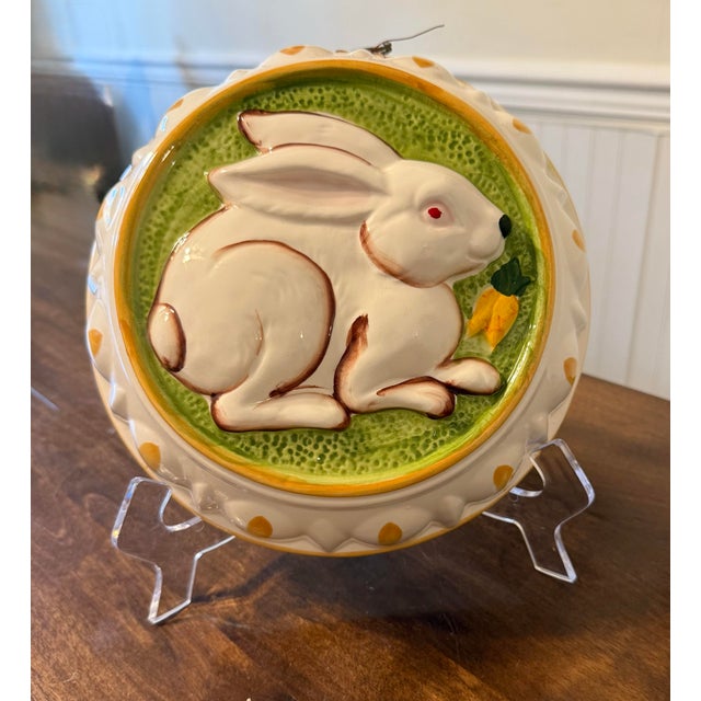 This is a charming vintage ceramic jello mold, prominently featuring a raised relief design of a white bunny with...