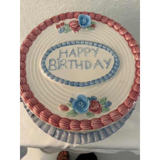 Charming vintage ceramic pedestal domed "Happy Birthday" cake plate features a garden themed pedestal plate surrounded by...