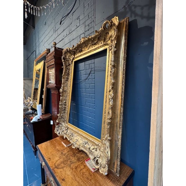 The product is a stunning 19th century French carved and water gilded frame, showcasing a classic and elegant design. The...