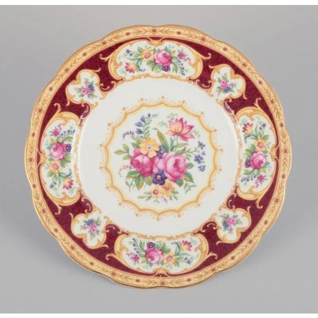 Royal Albert, England. A set of six "Lady Hamilton" plates with polychrome floral motifs. Gold decoration. Ca. 1930s....