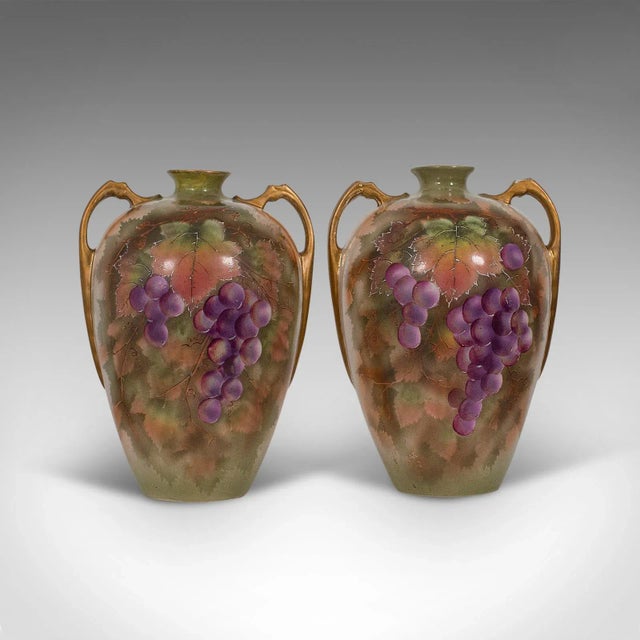 This is a pair of vintage wine Amphora. An English, ceramic decorative vessel with hand painted finish, dating to the...