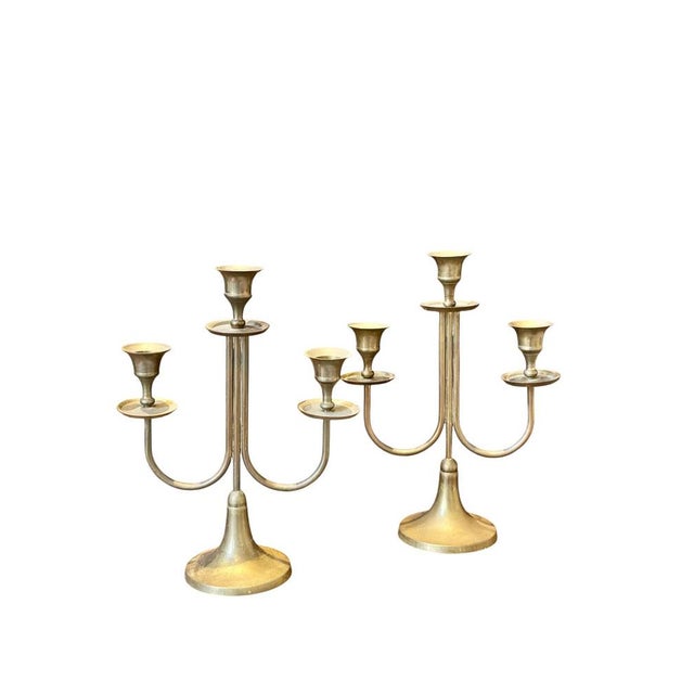 Art Deco candelabras, circa 1930, made of bronze with a brass finish and in a neoclassical style. They feature clean,...