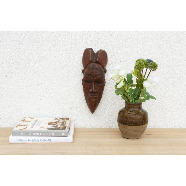 This exquisite Baule mask, originating from the Ivory Coast, is a testament to the refined artistry and cultural...