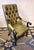 Vintage Chesterfield lounge chair in olive green tufted leather dating from about 1970. Well upholstered, very comfortable.