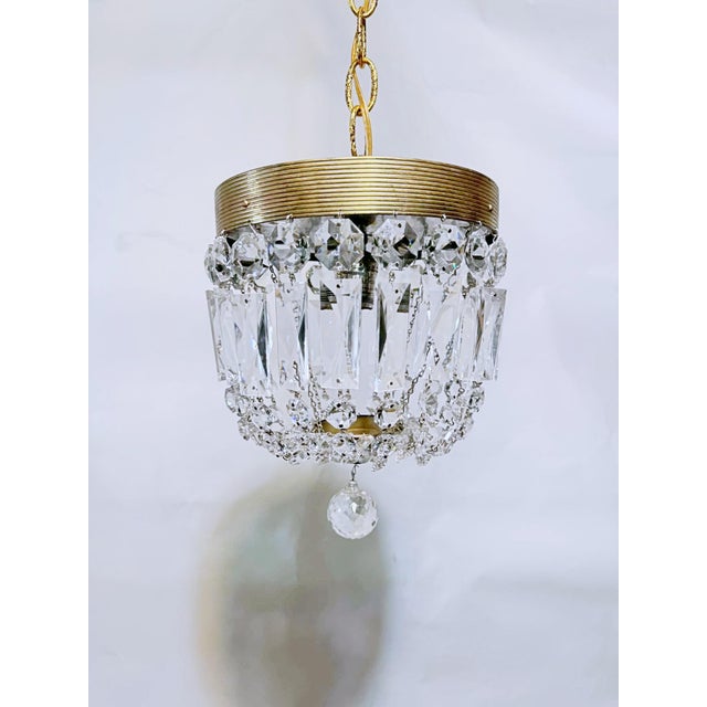 This beautiful vintage crystal chandelier combines classic elegance with timeless sophistication. Featuring a ribbed brass...