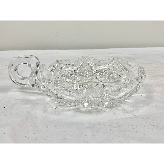 Beautiful vintage cut glass dish with handle. Intricate design. Perfect for use serving, holding candies or as a display...