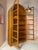 An exceptional arched display cabinet from Dyrlund, crafted from teak. The striking, architectural arched shape and two...