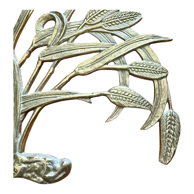 Striking vintage brass wall sculpture depicting an abundant cluster of stylized grasses, reeds, and seed heads. The...