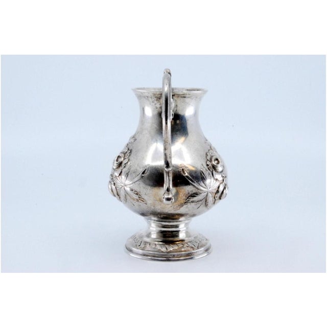 Silver Wine Jug with Engraved Floral Motifs, in Very Good conditions. Designed 1890 to 1919 This piece has an attribution...