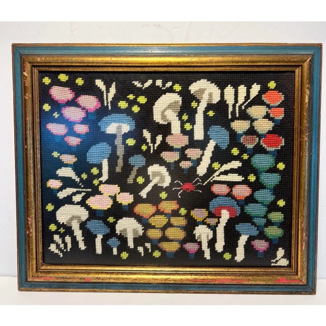 Whimsical needlepoint of colorful mushrooms likely from the 1970's. Mushrooms in shades of blue, pink, ivory and red pop...