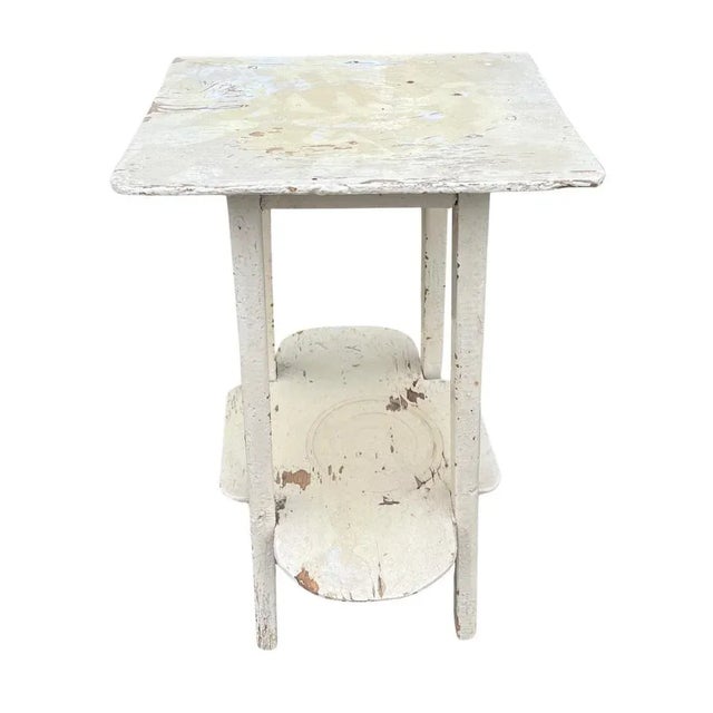 This vintage side table from Hungary with a lower shelf is a charming piece of furniture crafted from quality wood in...