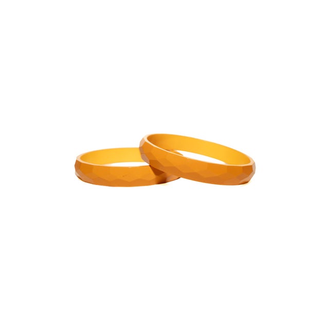 These vintage 1930's bakelite bangle bracelets are diamond faceted and of the color of amber orange mustard. Sold as a set...