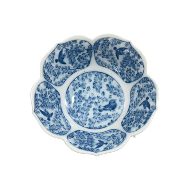 Vintage porcelain 6 inch lotus flower bowl with subtly ribbed petals in a blue and white pattern of birds in the trees....