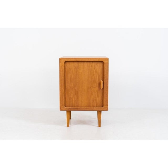 Compact cabinet with tambour door by CFC Silkeborg (Denmark, 1960s). The cabinet is made out of teak and features stunning...