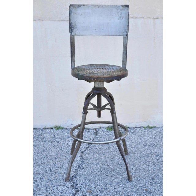 Antique American Industrial Metal Drafting Work Stool with Oak and Cane Seat. Item features bentwood oak round cane seat,...