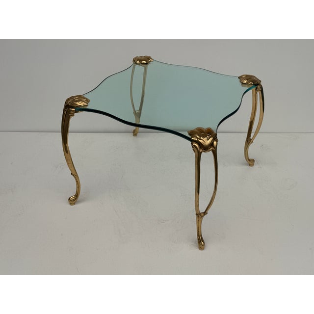 Brass and glass coffee / side / end table in the manner of Maison Jansen with beautiful Rococo style legs and unique shape...