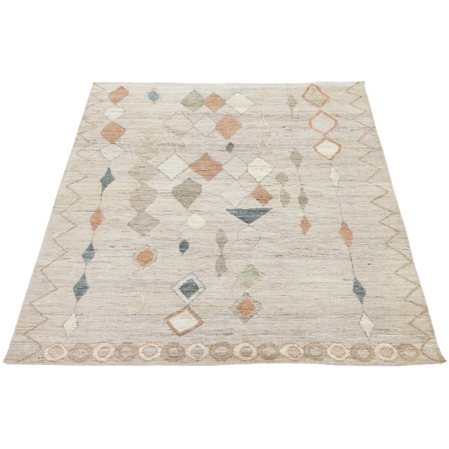 Transform your space with this Modern Moroccan-style area rug, hand-knotted from high-quality wool. Featuring a neutral...
