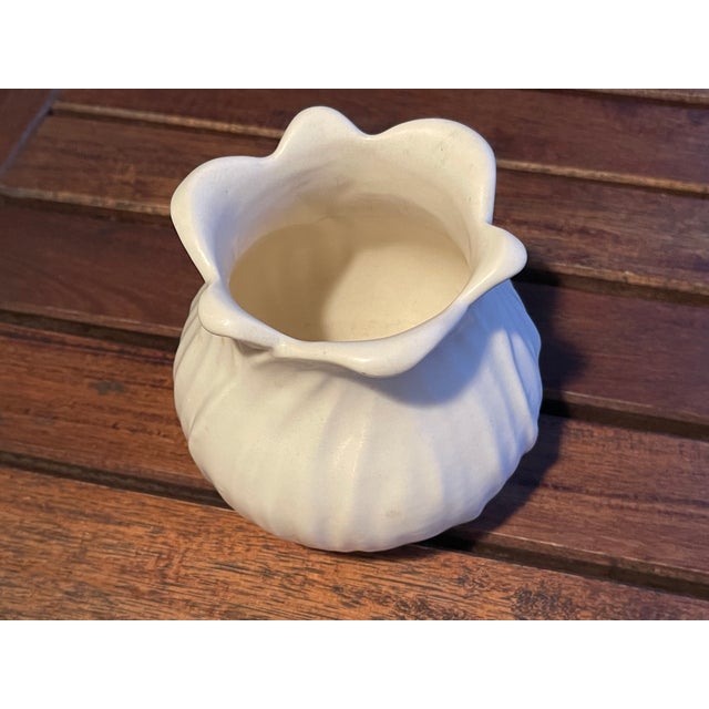 Here is one of the more desirable and unique stylized vases from Red Wing in a tulip form. It is a creamy white vase and...