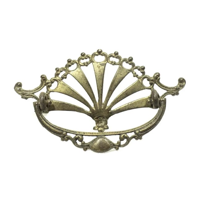 Antique brass bail pull with an ornate cut out Victorian design. Priced each. The manufacturer and exact date of creation...