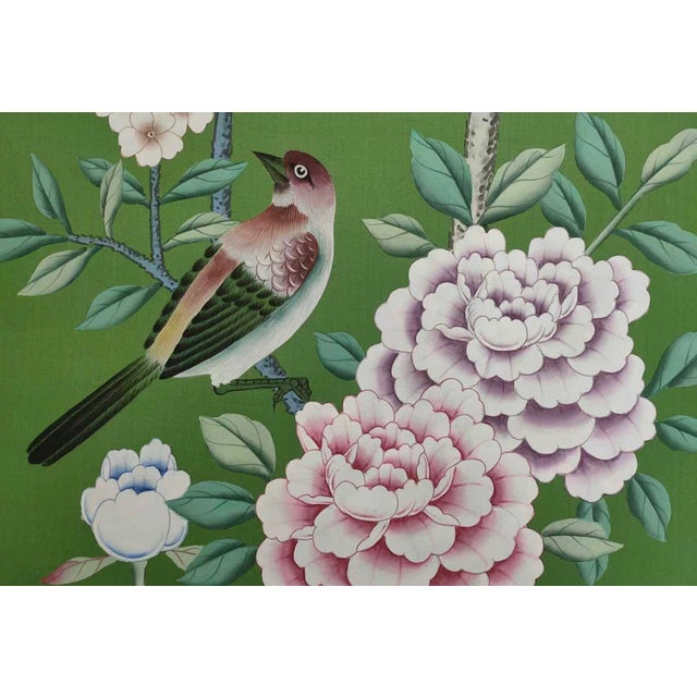 A luxurious hand painted wallpaper sample featuring a graceful bird surrounded by blooming peony flowers and delicate...