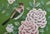 A luxurious hand painted wallpaper sample featuring a graceful bird surrounded by blooming peony flowers and delicate...