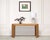 A striking 1970s midcentury pencil reed rattan console table, constructed in the Organic Modern and Tropical styles after...