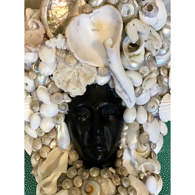 Black Mermaid Wall Sconce covered in White Shells