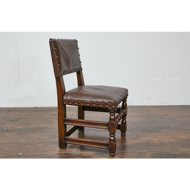 An English child's chair from circa 1880 with turned legs and oilcloth upholstery. This charming English child's chair...