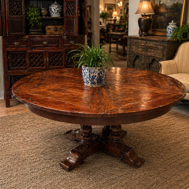 Theodore Alexander for Castle Bromwich antique wood expandable dining table, having a circular top, above baluster form...
