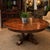 Theodore Alexander for Castle Bromwich antique wood expandable dining table, having a circular top, above baluster form...