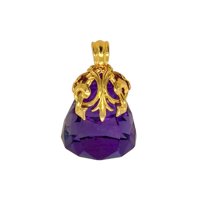 This striking Art Nouveau fob charm showcases a vibrant faceted amethyst held within a flowing open‑work 14K gold mount....