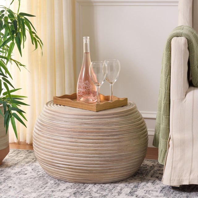 Transform your living space with the elegance of the Hilario Round Accent Table in a stunning grey white wash finish....