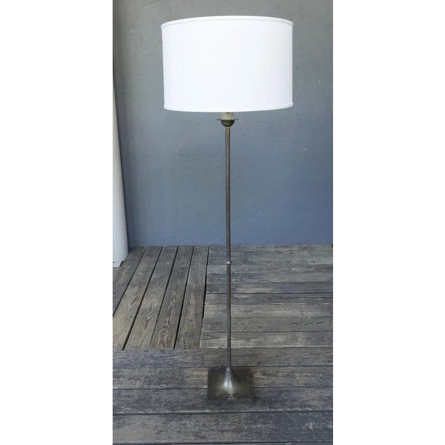 A modern style floor lamp with original dark silvered plating. The lamp has a fluted stem and is mounted on a square base....