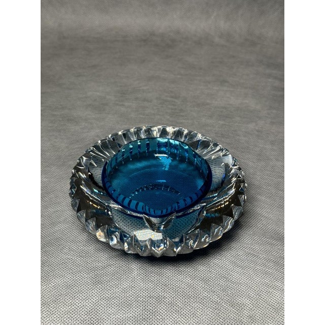 Vintage Murano glass ashtray in deep blue color. Features ribbed sides and solid glass construction typical for Murano...