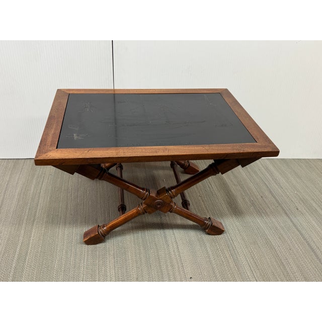 Design Plus Gallery presents a Schooner Engraved Low Table with Campaign Styling. The stylish table has an engraved slate...