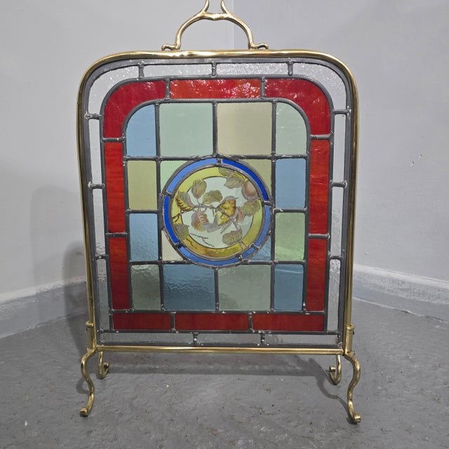 Very nice Victorian brass fire screen wiith coloured leaded glass, and central hand painted robin, in very good overall...